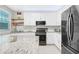 Bright kitchen featuring white cabinetry, granite countertops, and modern appliances, creating a clean and inviting space at 350 Westchester Way, Canton, GA 30115