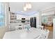 A kitchen with white cabinets, granite countertops, and stainless steel appliances opens up to a cozy living area at 350 Westchester Way, Canton, GA 30115