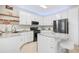 Well-lit kitchen with white cabinets, granite countertops, stainless steel appliances, and a functional center island at 350 Westchester Way, Canton, GA 30115