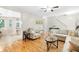 Open-concept living room with hardwood floors, neutral furniture, and a seamless transition to the kitchen area at 350 Westchester Way, Canton, GA 30115