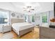 Comfortable primary bedroom with tray ceiling, wood floors, and bright natural light at 350 Westchester Way, Canton, GA 30115