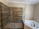 Primary bath with glass shower, soaking tub, and elegant tile work at 3641 Ridge Towne Dr, Duluth, GA 30096