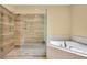 Primary bath with glass shower, soaking tub, and elegant tile work at 3641 Ridge Towne Dr, Duluth, GA 30096