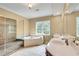 A primary bathroom featuring tile flooring, double vanity, separate shower, and soaking tub at 3641 Ridge Towne Dr, Duluth, GA 30096