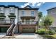 Exterior view of a 3 story home with a basement garage and wooden deck at 3641 Ridge Towne Dr, Duluth, GA 30096