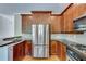 Kitchen including stainless steel refrigerator, granite countertop and hardwood floors at 3641 Ridge Towne Dr, Duluth, GA 30096