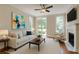 Bright living room with fireplace, white couch, ceiling fan, and art at 3641 Ridge Towne Dr, Duluth, GA 30096