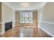 Living room with fireplace, light-colored walls and bright window at 3641 Ridge Towne Dr, Duluth, GA 30096
