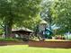 Charming community playground featuring a gazebo, slide, and climbing structure surrounded by mature trees at 3641 Ridge Towne Dr, Duluth, GA 30096