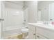 Clean, well-lit bathroom with a shower-tub combo and white vanity at 4358 Grove Field Ct, Suwanee, GA 30024
