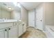 Bathroom featuring a double vanity, tile floors, and white cabinets at 4358 Grove Field Ct, Suwanee, GA 30024