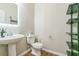 Contemporary half bathroom featuring a sleek vanity and decorative shelving at 4358 Grove Field Ct, Suwanee, GA 30024