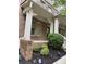 Charming brick front porch with columns, hanging baskets, and landscaped garden at 4358 Grove Field Ct, Suwanee, GA 30024