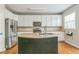 Bright kitchen with a center island, stainless steel appliances, and ample cabinet space at 4358 Grove Field Ct, Suwanee, GA 30024