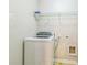 Convenient laundry room includes a washing machine and shelving at 4358 Grove Field Ct, Suwanee, GA 30024