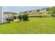 Well-maintained backyard featuring a patio area with seating, a basketball hoop, and lush green grass at 1031 High Tide Ct, Loganville, GA 30052