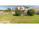 Expansive backyard featuring a well-maintained lawn, mature trees, a wooden fence, and a shaded pergola at 1031 High Tide Ct, Loganville, GA 30052
