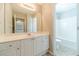 Bright bathroom featuring a white vanity, large mirror and a separate toilet and shower area at 1031 High Tide Ct, Loganville, GA 30052