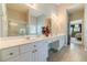 Bright bathroom with double sinks and access to the adjacent primary bedroom at 1031 High Tide Ct, Loganville, GA 30052