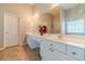 Bright bathroom features double sinks and ample counter space in a well-lit area at 1031 High Tide Ct, Loganville, GA 30052