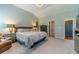Spacious bedroom with a vaulted ceiling, neutral paint, and access to the ensuite bath at 1031 High Tide Ct, Loganville, GA 30052