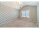 This bedroom features patterned wallpaper, vaulted ceilings, and a light neutral carpet at 1031 High Tide Ct, Loganville, GA 30052