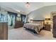 Spacious bedroom with a vaulted ceiling, neutral paint, and lots of natural light at 1031 High Tide Ct, Loganville, GA 30052