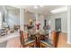 Open dining area with hardwood floors, glass table, and views to living room at 1031 High Tide Ct, Loganville, GA 30052
