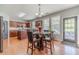 Dining area with wood flooring and a glass-topped table with seating for four at 1031 High Tide Ct, Loganville, GA 30052