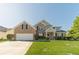 Charming brick two-story home with a well-manicured lawn and attached two-car garage at 1031 High Tide Ct, Loganville, GA 30052