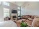 Comfortable living room with tall ceilings, a fireplace, and large windows at 1031 High Tide Ct, Loganville, GA 30052