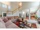 Inviting living room features a soaring ceiling, large windows, and an open floor plan leading to the kitchen at 1031 High Tide Ct, Loganville, GA 30052