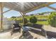 Covered patio with outdoor seating, BBQ grill, a well-manicured lawn, and view of a hillside at 1031 High Tide Ct, Loganville, GA 30052