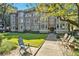 Charming brick building with large windows, surrounded by a lush green lawn and mature trees at 1156 Piedmont Ne Ave # B3, Atlanta, GA 30309
