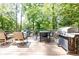 Spacious wooden back deck with an outdoor grill and ample seating for entertaining guests at 1295 Lindenwood Ne Ln, Brookhaven, GA 30319