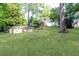 Expansive backyard featuring a well-maintained lawn, tiered garden beds, and a private setting for outdoor enjoyment at 1295 Lindenwood Ne Ln, Brookhaven, GA 30319