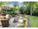 Serene backyard with a deck, fire pit area, and lush landscaping, perfect for relaxing and entertaining guests at 1295 Lindenwood Ne Ln, Brookhaven, GA 30319