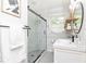 Modern bathroom with a glass-enclosed shower, white subway tile, and black hardware at 1295 Lindenwood Ne Ln, Brookhaven, GA 30319