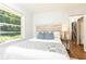 Bright bedroom with a large window providing natural light and a view of the lush yard at 1295 Lindenwood Ne Ln, Brookhaven, GA 30319
