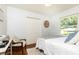 Comfortable bedroom with hardwood floors, a white rug, and a large window overlooking the yard at 1295 Lindenwood Ne Ln, Brookhaven, GA 30319