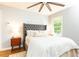 Cozy bedroom with a tufted headboard, neutral decor, hardwood floors, and natural lighting at 1295 Lindenwood Ne Ln, Brookhaven, GA 30319