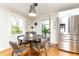 Cozy dining area adjacent to kitchen with hardwood floors, modern lighting, and stainless steel refrigerator at 1295 Lindenwood Ne Ln, Brookhaven, GA 30319