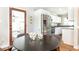 Cozy dining area adjacent to kitchen with hardwood floors, modern lighting, and stainless steel refrigerator at 1295 Lindenwood Ne Ln, Brookhaven, GA 30319