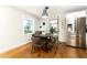 Cozy dining area adjacent to kitchen with hardwood floors, modern lighting, and stainless steel refrigerator at 1295 Lindenwood Ne Ln, Brookhaven, GA 30319