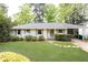 Charming one-story home with a well-manicured lawn, fresh landscaping and a painted brick exterior at 1295 Lindenwood Ne Ln, Brookhaven, GA 30319
