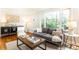 Comfortable living room with hardwood floors, stylish decor, and a large window offering natural light and views at 1295 Lindenwood Ne Ln, Brookhaven, GA 30319