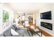 Bright and airy living room featuring hardwood floors, a modern fireplace, and a large window with green views at 1295 Lindenwood Ne Ln, Brookhaven, GA 30319