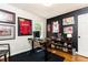 Well-lit office space with hardwood floors, black accent wall, and vintage sports decor at 1295 Lindenwood Ne Ln, Brookhaven, GA 30319