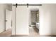 Stylish bathroom with sliding barn door, soaking tub and glass enclosed shower at 2745 S Bamby Ne Ln, Brookhaven, GA 30319