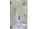Modern bathroom features an enclosed glass shower with stylish tile work, offering a spa-like experience at 2745 S Bamby Ne Ln, Brookhaven, GA 30319
